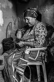 elderly woman basket weaving